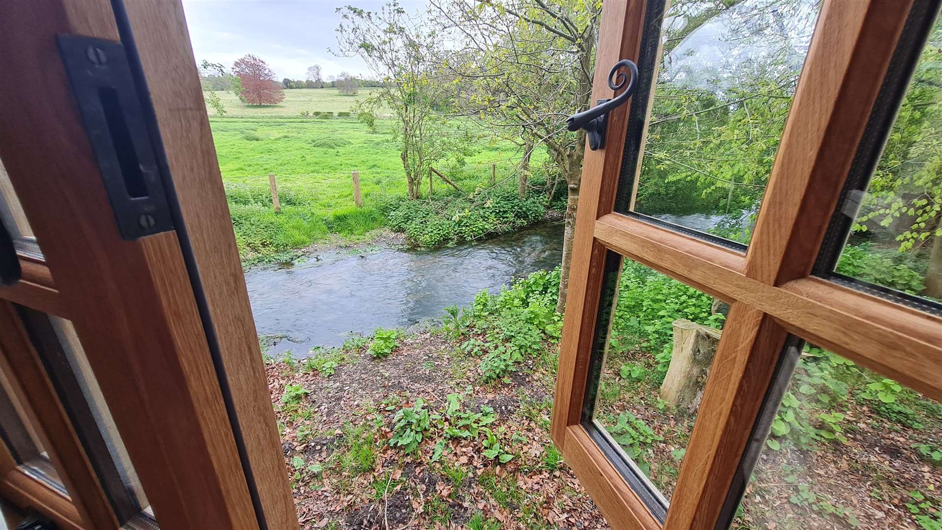 The view from the bedroom looks over a babbling brook