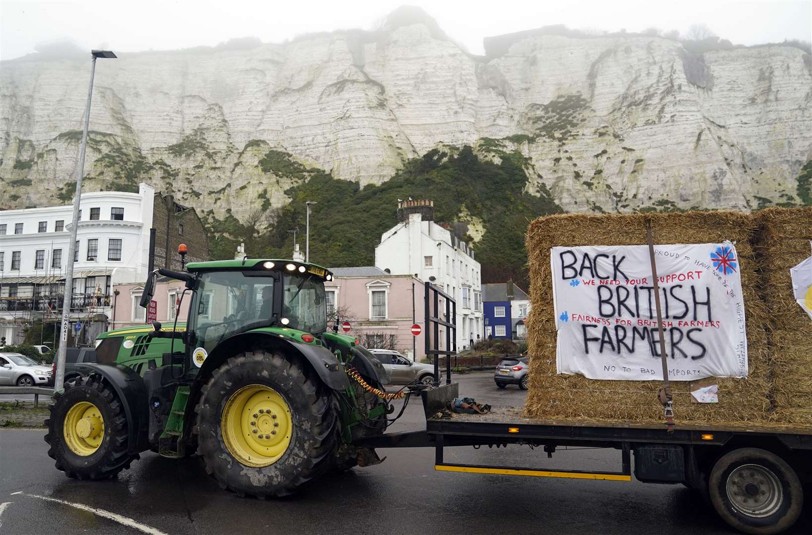 Farmers using their vehicles to protest against cheap meat imports drive past the Port of Dover in Kent (Andrew Matthews/PA)