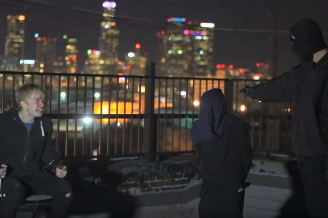Sam Golbach (left) is pranked in the video by Folkestone's Sam Pepper (with the gun) and Colby Brock