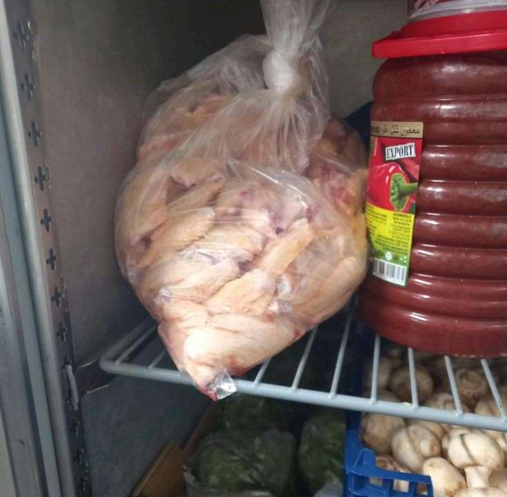 Raw chicken being stored in a fridge above vegetables at the Blue and White Cafe. Picture: Ashford Borough Council