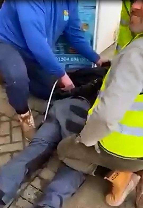 A still from the video, which revealed the moment a group tied a man up at Whitfield petrol station