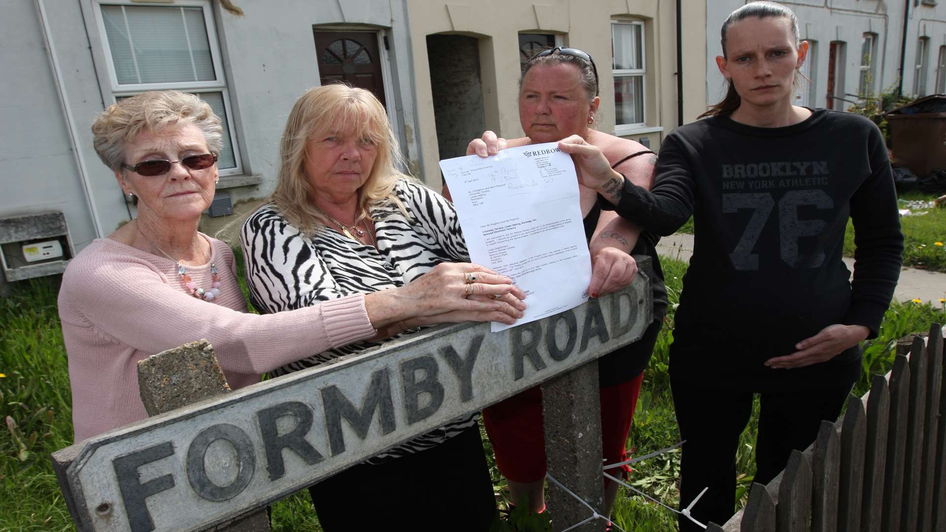 Kayleigh Peachell with other families who live in Formby Terrace.
