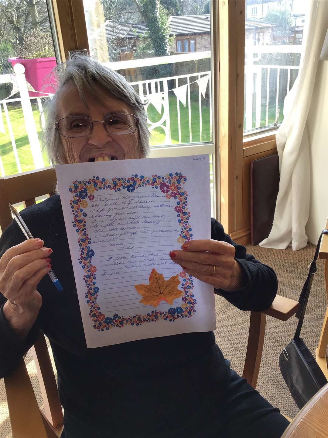 Margo with her letter at Rogers House Residential Care Home in Wigmore