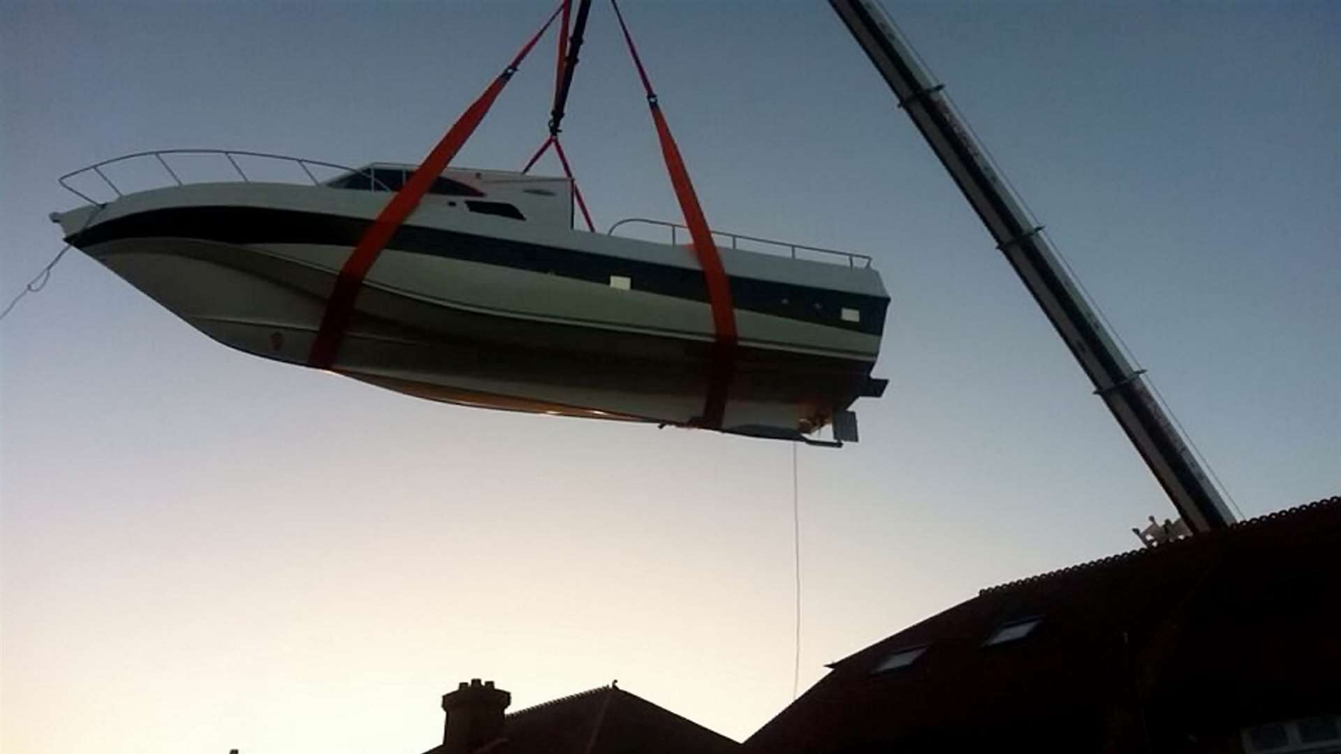 The yacht had to be lifted over the house by crane. Picture: SWNS