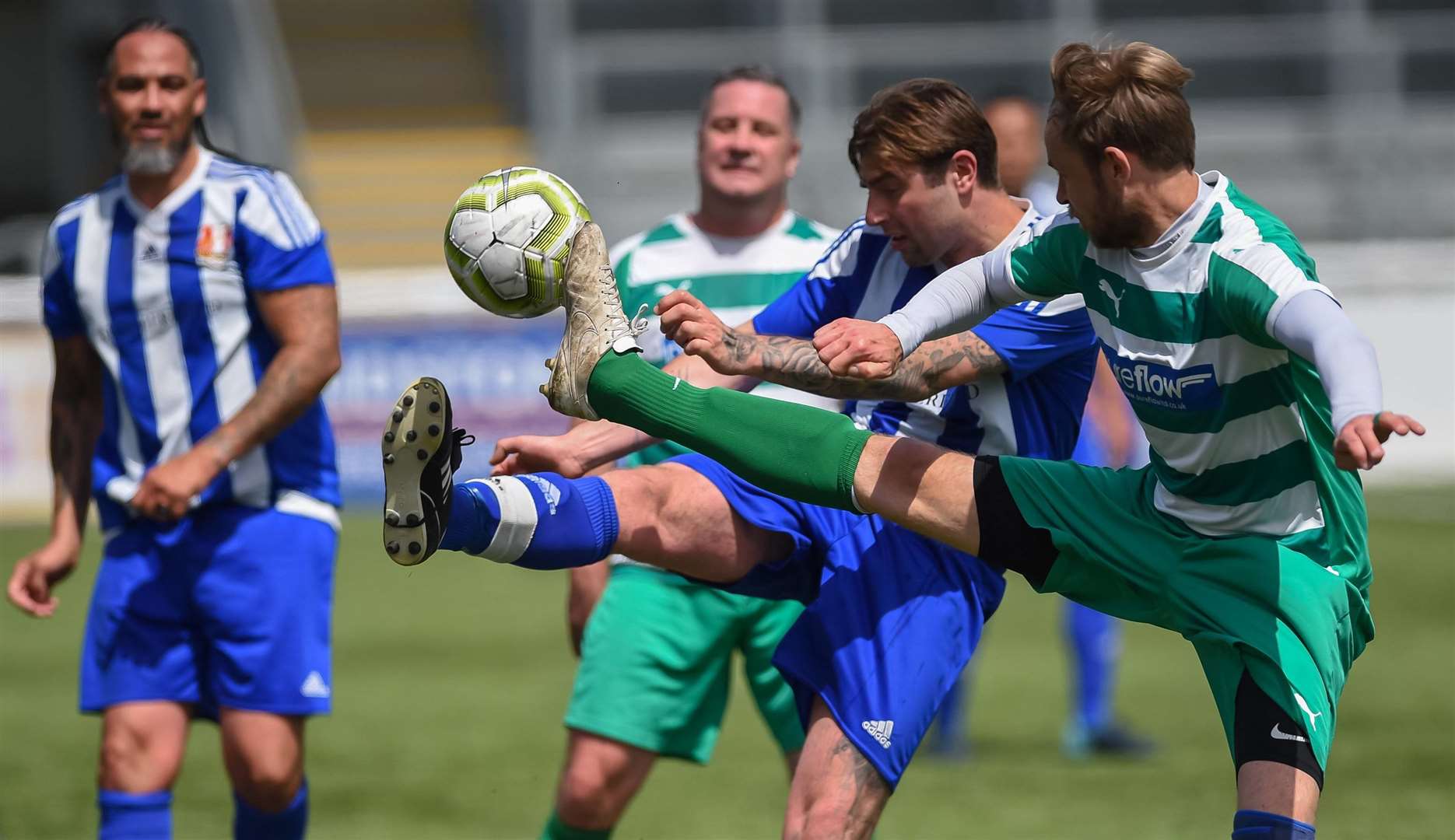 Metrogas Vets (blue) compete for possession against New Ash Green Vets. Picture: PSP Images
